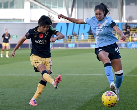 West Ham’s Riko Ueki attempts a shot despite the attentions of Manchester City’s Leila Ouahabi