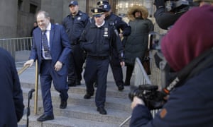 Harvey Weinstein, left, leaves a Manhattan courthouse after closing arguments in his rape trial in New York.