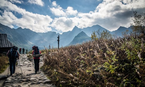 Tourists hike in the Tatra mountains, Poland.