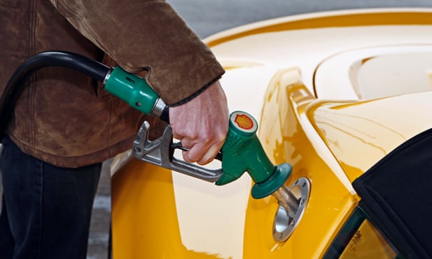 A man uses an unleaded petrol pump