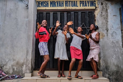 Young Jewish Nigerians singing and dancing outside their synagogue.