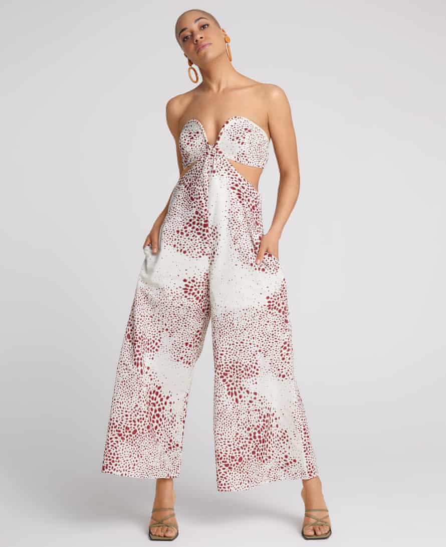 Actor Cush Jumbo in floral jumpsuit against grey background