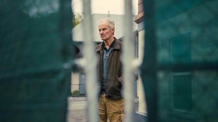 Tony Powell seen through a gate in a scene from the documentary Last Guest Of The Holloway Motel.