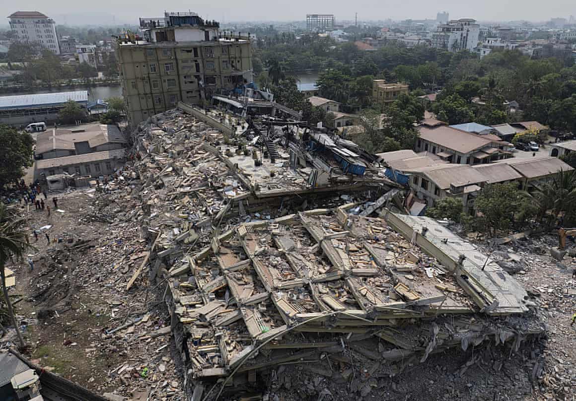 Rescuers search for survivors at the collapsed Sky Villa residence in Mandalay, Myanmar