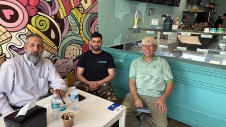 three men sitting at a table