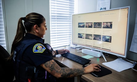 police officer looks at computer screen