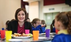 Bridget Phillipson sits at a table with children eating breakfast