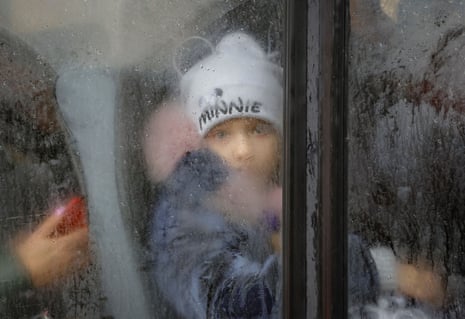 A boy evacuated from the city of Kherson looks on in a bus heading to Crimea.