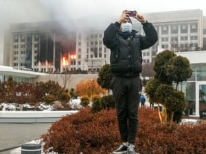 A man takes a picture by the burning mayor’s office. Kazakh media outlets cited the Interior Ministry as saying 317 police and national guard servicemen were injured and eight killed ‘by the hands of a raging crowd’.