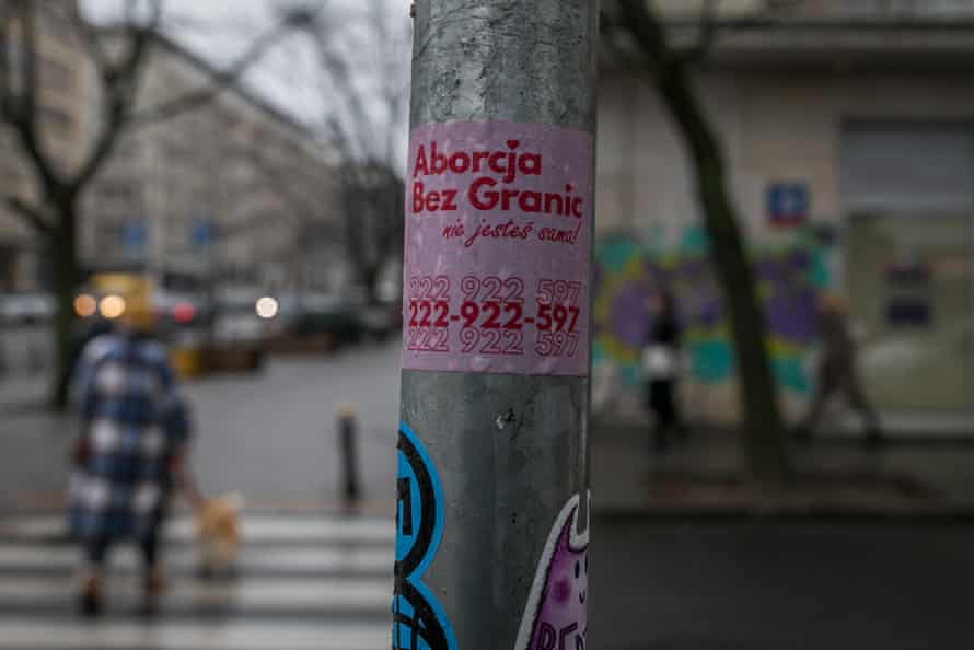 A sticker on a roadside post in central Warsaw gives the number of Abortion Without Borders