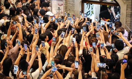 Fans record videos on their smartphones as boy band Modern Brothers performs during a live webcast at Andong Old Street on June 30, 2018 in Dandong, Liaoning Province of China. Modern Brothers has over 20 million fans on the Tik Tok app, a short-video social platform powered by music, and Tik Tok is very popular in China. (Photo by Visual China Group via Getty Images)