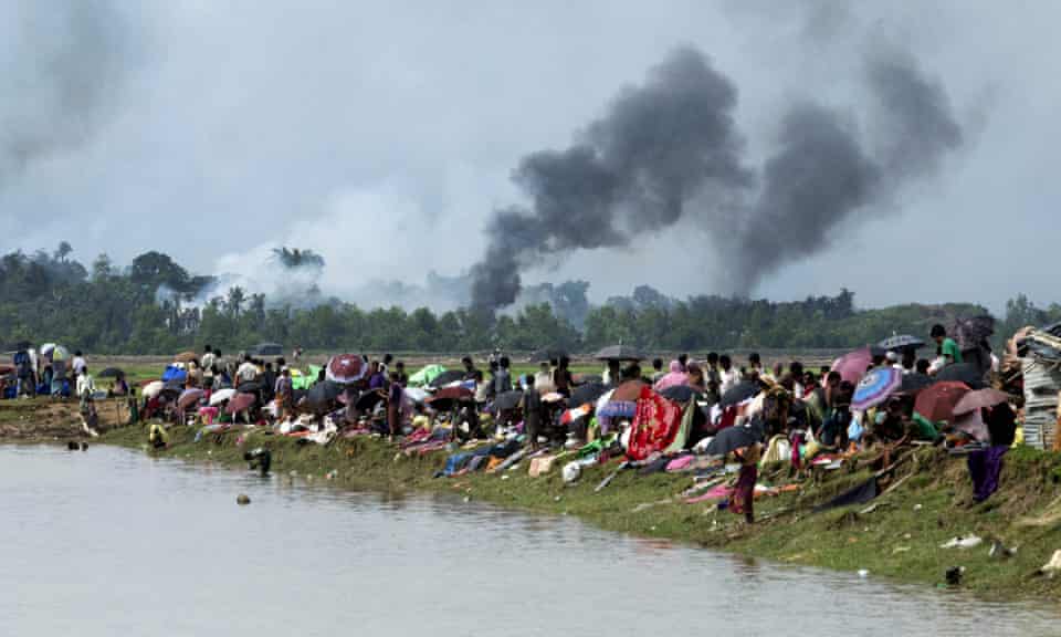 Smoke billows above what is believed to be a burning village in Rakhine state as members of the Rohingya Muslim minority take shelter in a no-man’s land between Bangladesh and Myanmar.