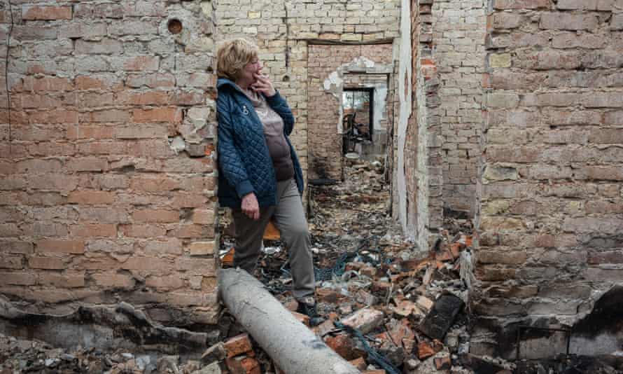 Inna, 53, smokes inside her burnt house in Ozera.