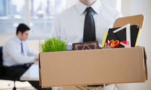 Male office worker carrying personal belongings from the office as if fired