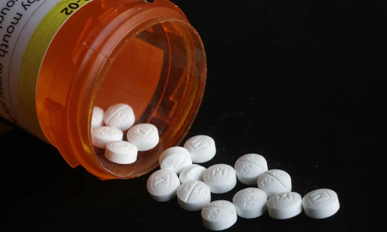 Oxycodone pills spilling out of container