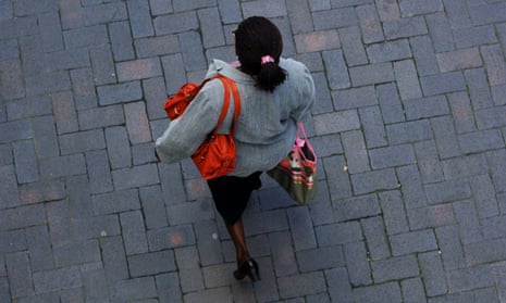 A woman walking down a street.