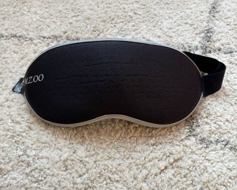 A Mzoo sleep mask laid out on a rug