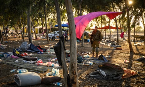 Members of the security forces continue to search for identification and personal effects at the Supernova music festival site where hundreds were killed and dozens taken by Hamas militants near the border with Gaza on 12 October in Re’im kibbutz, Israel