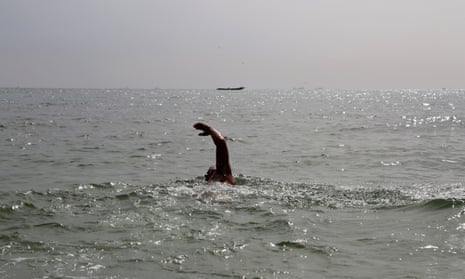 The arm of Ben Hooper sticking out of the sea as he takes a stroke in the Atlantic
