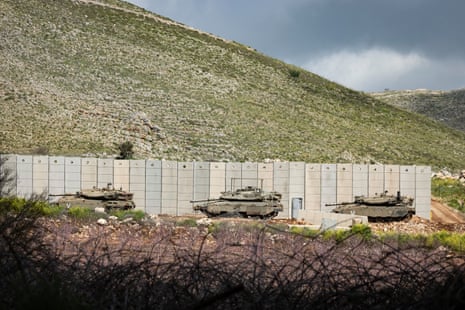 Israeli tanks are seen on the Israeli side of the border with Lebanon in the Upper Galilee in northern Israel on Thursday.