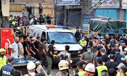 Residents and medics near an emergency vehicle