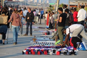 Illegal sellers of fake branded clothes on Barceloneta beach