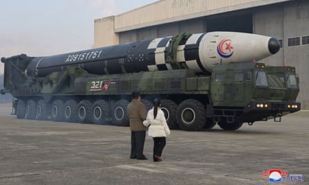 North Korean leader Kim Jong Un inspects an intercontinental ballistic missile with his daughter.