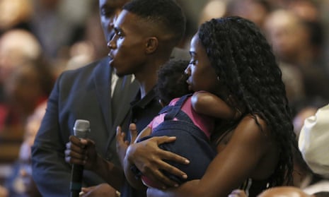 Dravon Ames and fiancée Iesha Harper, with 1-year-old daughter London, at a community meeting about police brutality.