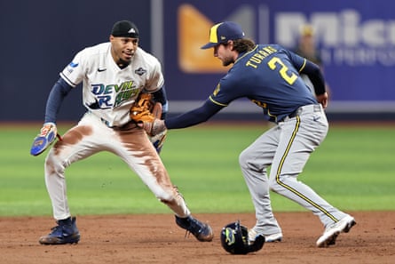 Brewers second baseman Brice Turang tags out the Raysâ Chandler Simpson during the first inning of Game 3 of the World Series on Monday night at Tropicana Field.