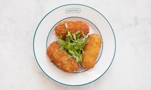 Three shrimp croquettes on a plate