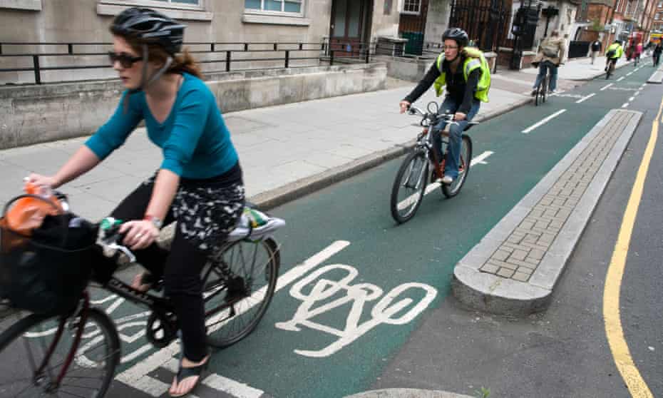 Cyclists riding in segregated cycling lane, London