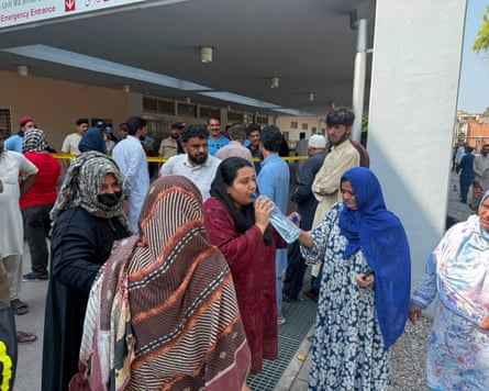 A group of women in hijabs outside the hospital