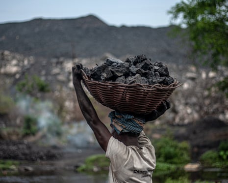 A man carries raw coal on his head collected from an open-cast mining site at Jharia coal mines in Dhanbad, Jharkhand, India, on April 5, 2026. As the Iran energy crisis chokes global gas supplies, India is ramping up production across its industrial belts to meet record summer demand.