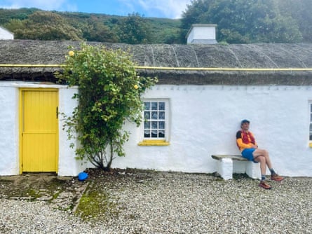 The writer takes a rest outside a traditional cottage.