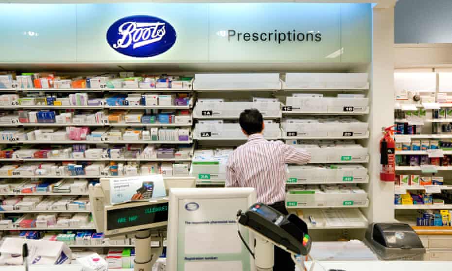 A back view of a pharmacist working in Boots the Chemist