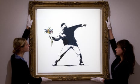 ‘Love is in the Air’ by Banksy, one of the artists now finding a new market. Photograph: Justin Tallis/AFP/Getty Images