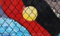 Indigenous flag behind wire fence