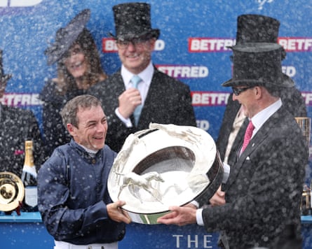 Winning jockey Wayne Lordan and trainer Aidan O’Brien celebrate with the trophy after sending out Lambourn to win the Derby.
