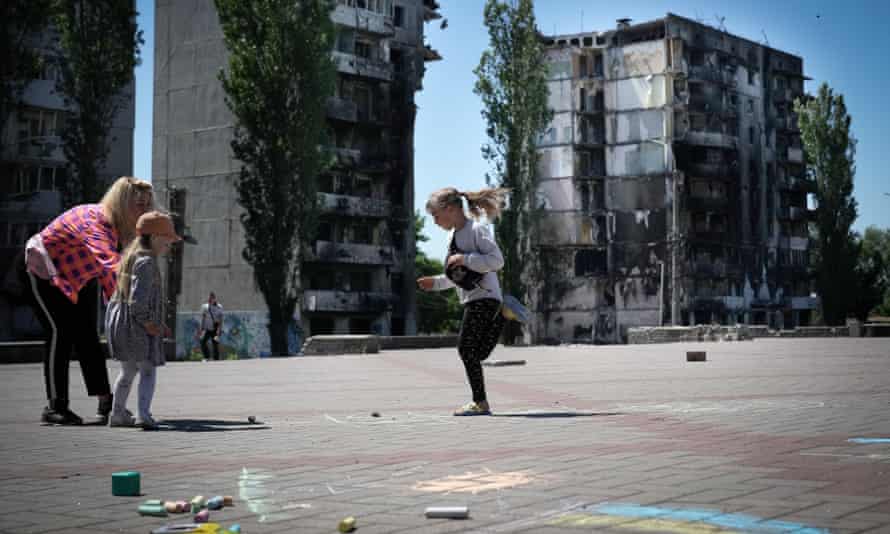 Volunteers from Borodianka community organise games and crafts for the children of the Kyiv suburb in the main square, against the backdrop of destroyed apartment blocks. The small town was occupied and heavily damaged during the Russian invasion with many of the facilities for children destroyed.