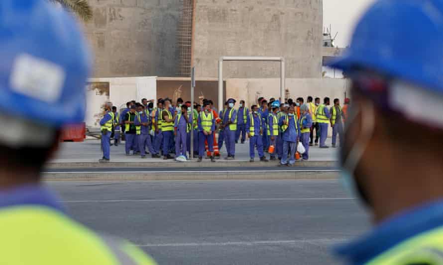 Labourers on the Katara Towers project in Lusail City leave the site at the end of the day. The Towers will host two luxury hotels that will open in time for the World Cup.