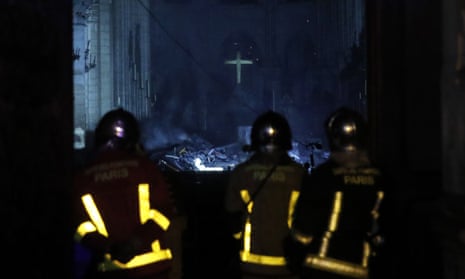 French firefighters enter the Notre Dame cathedral as flames are burning the roof in Paris, France.
