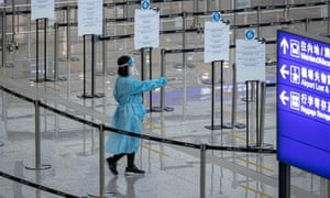 A health worker directs travellers in Hong Kong airport’s arrival hall last month