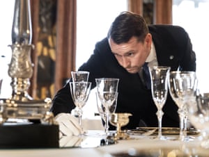 A service staff in white gloves sets a table as preparations are underway in the Oranjezaal ballroom in the royal palace Huis ten Bosch for the Nato dinner that Dutch King Willem-Alexander and Queen Maxima are offering to participating heads of state and government