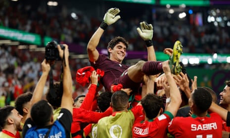 Yassine “Bono” Bounou is hoisted in the air by his Morroco teammates following their penalty shootout victory over Spain.