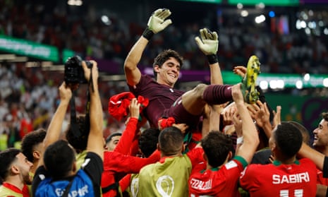 Morocco players lift up their goalkeeper, Yassine Bounou, after beating Spain 3-0 on penalties in the last-16 match at the Qatar World Cup.