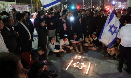 Israeli youths hold a candlelit vigil at the site of the attack in occupied East Jerusalem