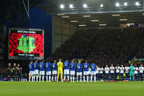 The two teams line up to observe a minutes silence.
