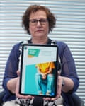 Hilary Cass holds up a tablet showing the cover of her review.