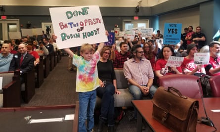 A young protester makes his point at an Arlington county board meeting discussing Amazon’s development plans in the Virginia, city. Photograph: Nandita Bose/Reuters