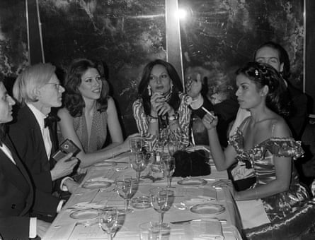Andy Warhol (left), Diane von Fürstenberg (centre), and Bianca Jagger (right) at a party in New York in January 1977.